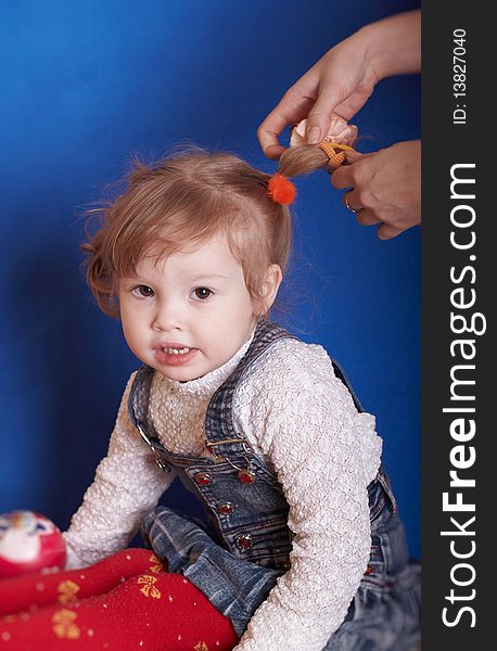 Which portrait of the girl is braided with hair. Which portrait of the girl is braided with hair