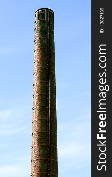 Brick pipe of old power station without a smoke against the sky. Brick pipe of old power station without a smoke against the sky.