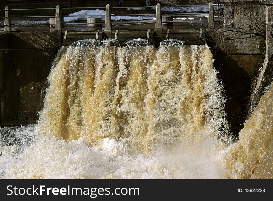 Small falls on an old dam and rough spring waters. Small falls on an old dam and rough spring waters.