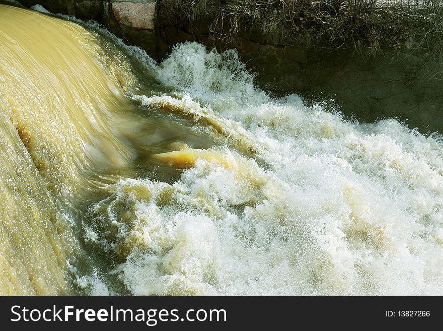 Small falls on an old dam and rough spring waters. Small falls on an old dam and rough spring waters.