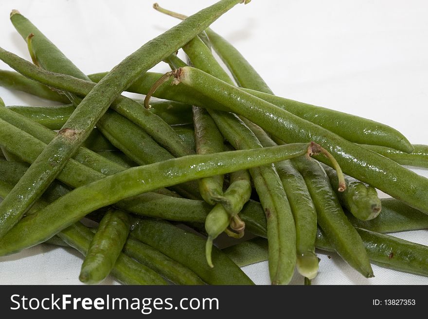 Uncooked String Beans on a white background