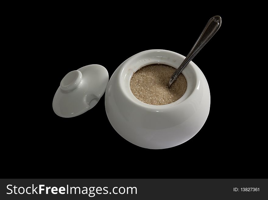 Brown sugar in a white bowl on a black background. Brown sugar in a white bowl on a black background
