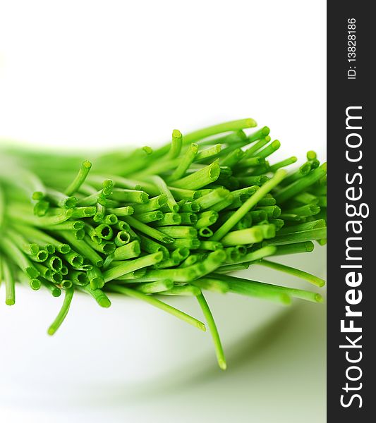 A bunch of fresh chives on white