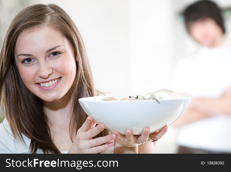 Beautiful girl with plate and boy