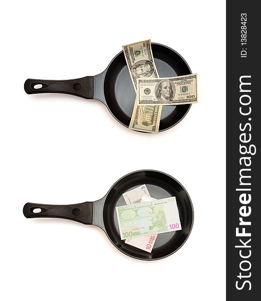 Two black frying pans with dollar and euro bills top view isolated. Two black frying pans with dollar and euro bills top view isolated