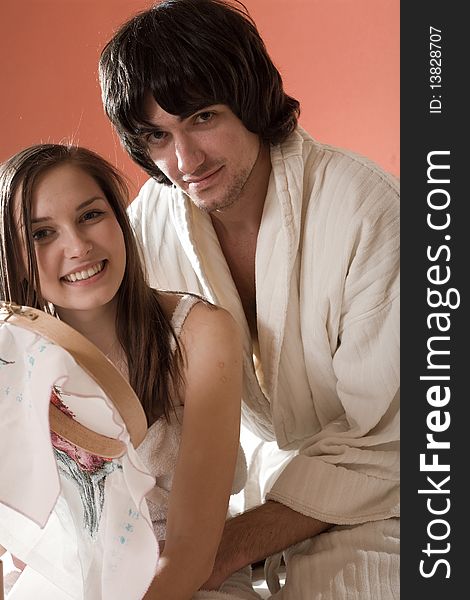 Girl with smile and boy in dressing gown. Girl with smile and boy in dressing gown
