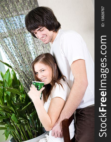 Girl with cup on chair and boy