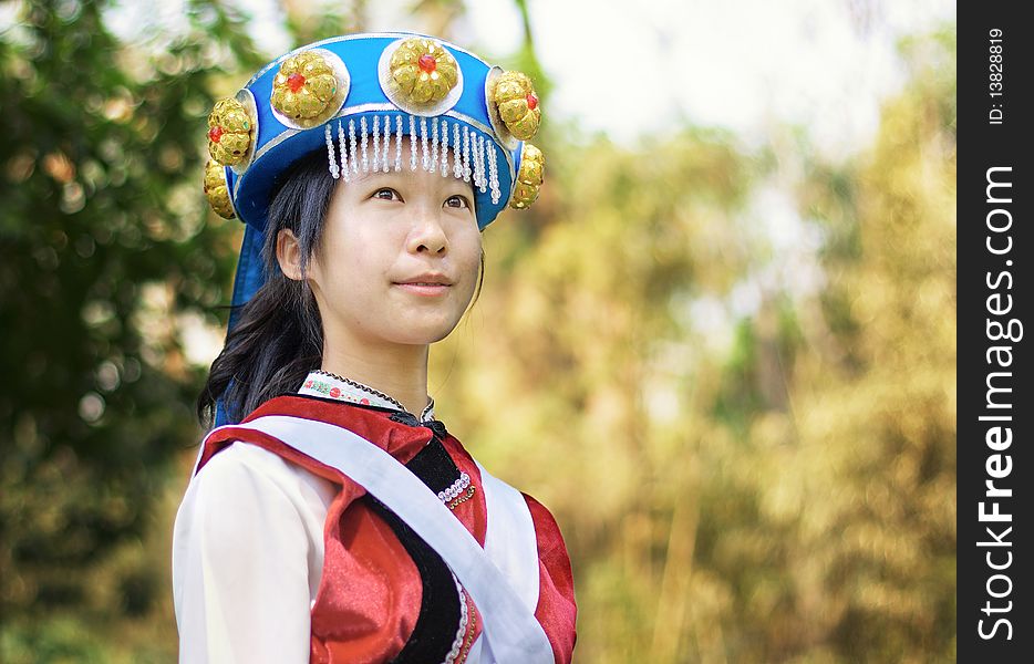 Beautiful Chinese woman dressed in the traditional clothes of the Naxi cultural minority. Beautiful Chinese woman dressed in the traditional clothes of the Naxi cultural minority