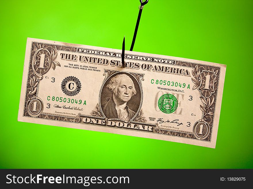 Dollar on hook on green background