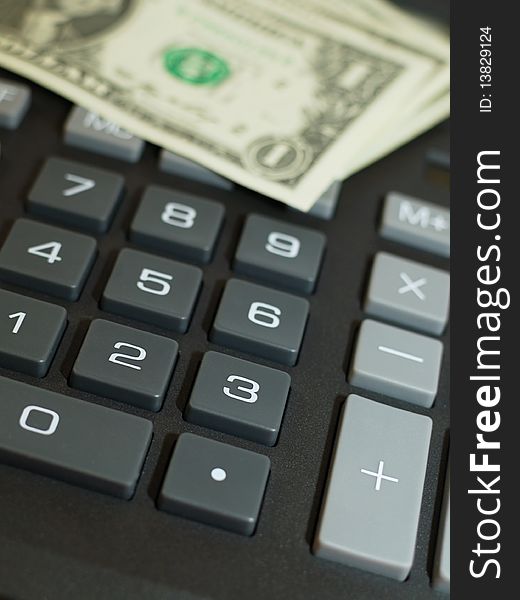 Money on keypad of a calculator close up. Money on keypad of a calculator close up