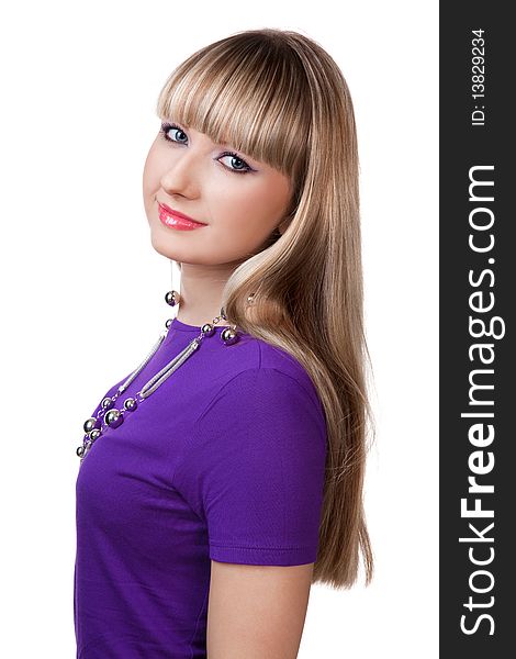 Beautiful girl in purple clothes with silver necklace studio shot