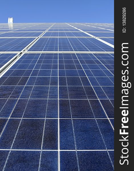 Modern solar photo voltaic panel close up with great blue cells details in a perspective view. Great for energy and environment themes.