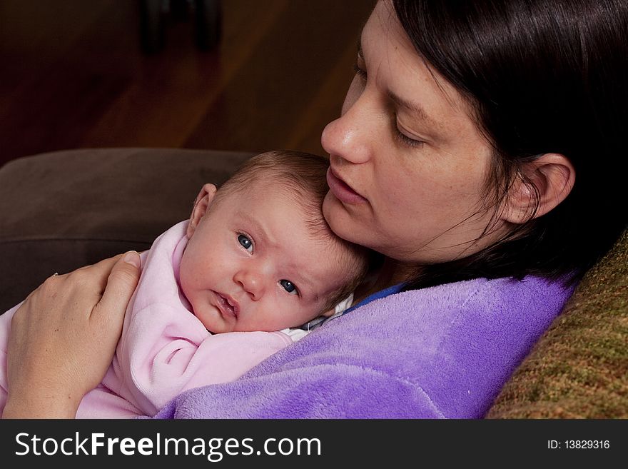 Mum giving her newborn baby a cuddle. Mum giving her newborn baby a cuddle