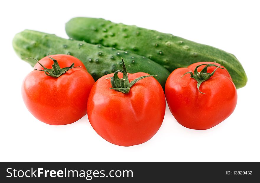 Fresh cucumbers and tomatoes on white background. Fresh cucumbers and tomatoes on white background