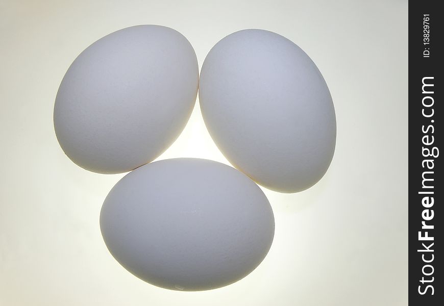 Boiled eggs.
Three eggs on a white background. Close-up.