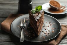 Plate With Slice Of Chocolate Cake And Fork On Table Royalty Free Stock Photo