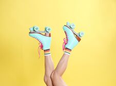 Young Woman With Retro Roller Skates On Color Background Royalty Free Stock Images