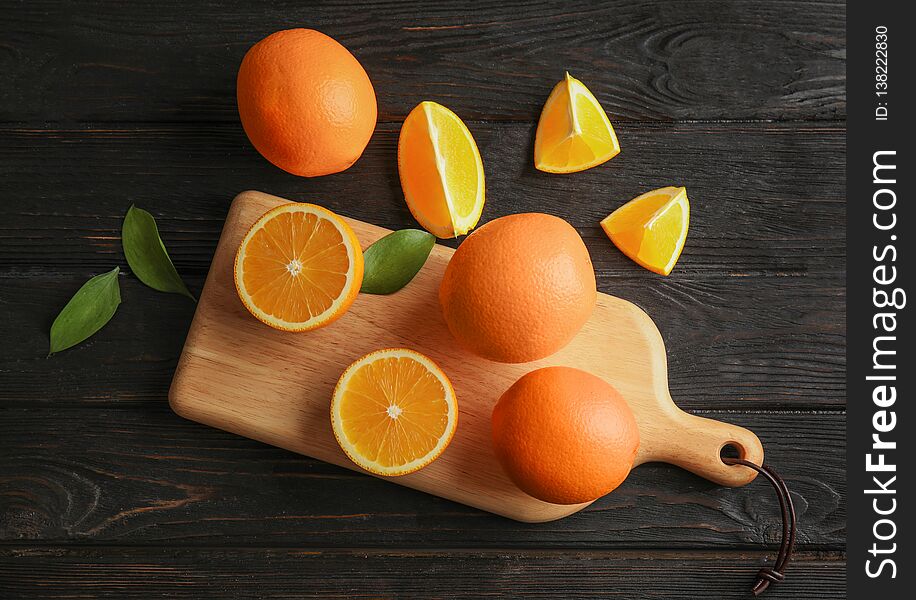 Fresh juicy oranges on wooden table