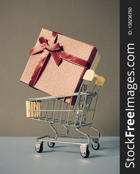 huge red gift box in shopping cart - online shopping