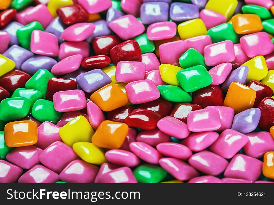 Chewing gum with different color background. Sweets and sweets