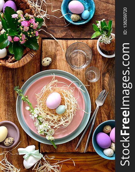 Easter table setting, holiday table home decor idea, flat lay composition with cutlery, Easter eggs and fresh flowers. Easter table setting, holiday table home decor idea, flat lay composition with cutlery, Easter eggs and fresh flowers