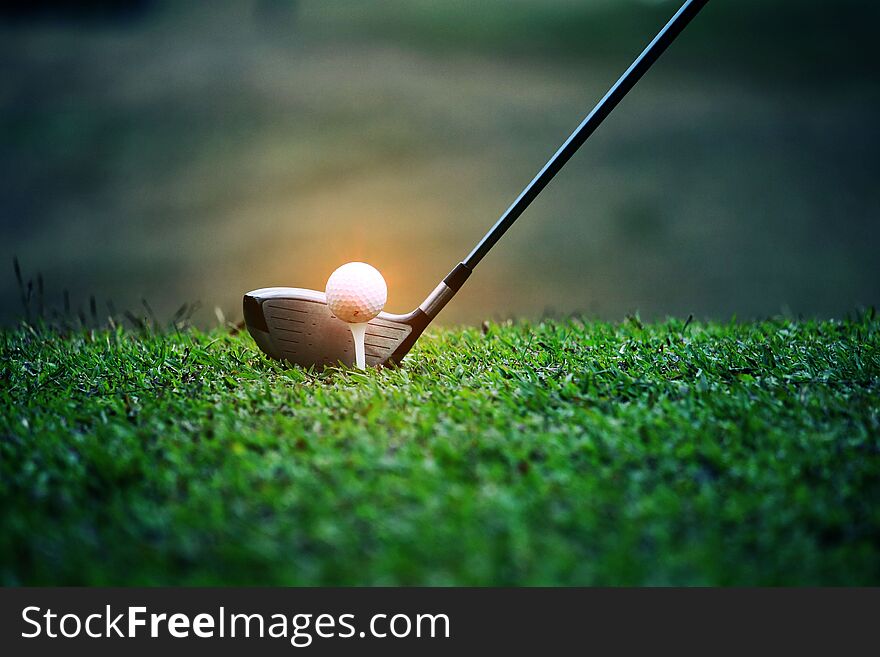 Blurred Golf Club And Golf Ball Close Up In Grass Field