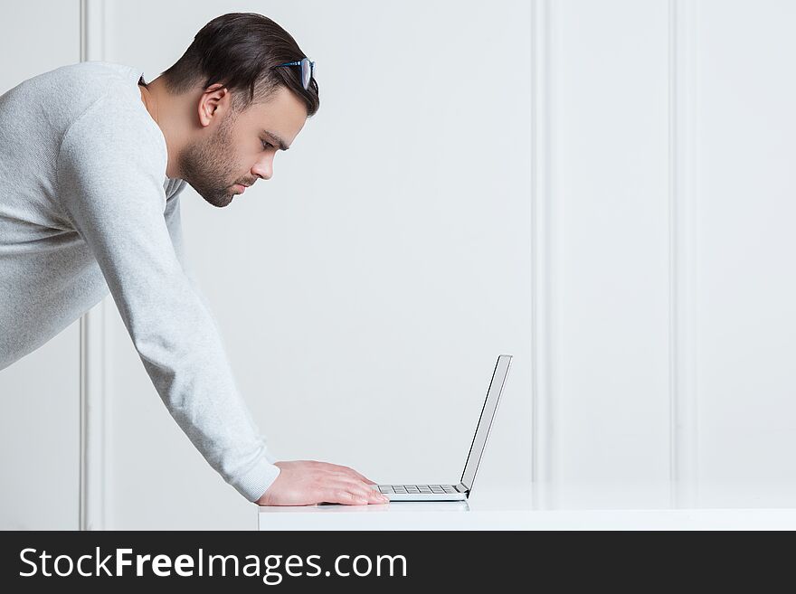 Business Concept. Young And Modern Businessman Using Laptop Over White Background