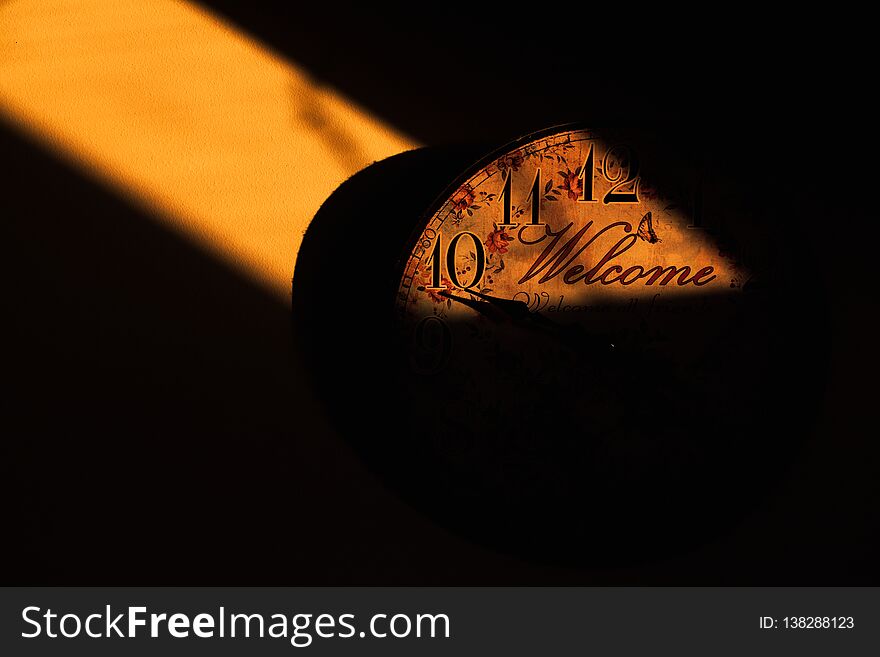 Clock on wall in apartmen in golden hour