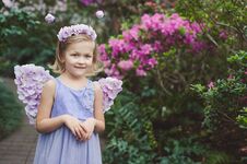 Free Girl Sniffing Flowers Of Azaleas. Flowering Azaleas In The Park Royalty Free Stock Photography - 138299537