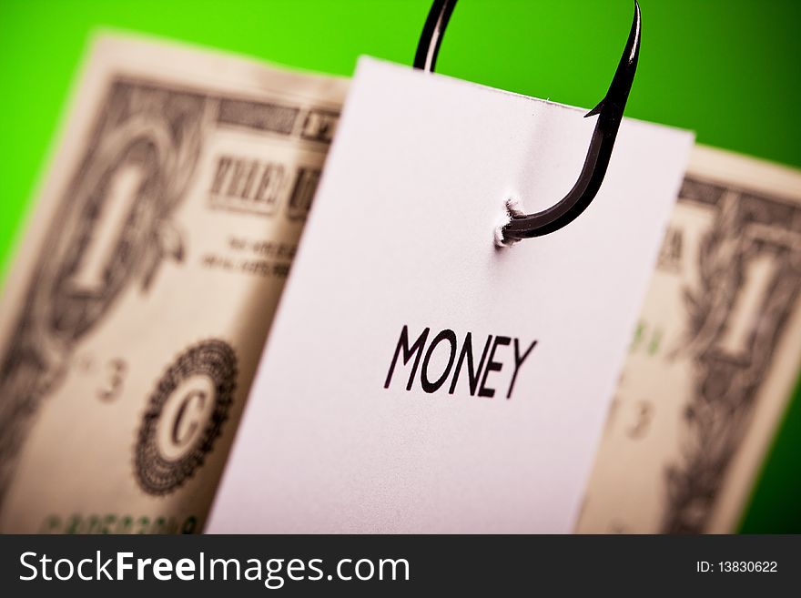 Piece of paper and dollar pierced on hook on colored background. Piece of paper and dollar pierced on hook on colored background