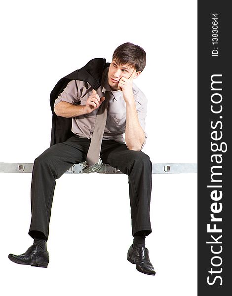 Young Businessman sitting on ladder, thinking