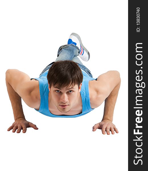 A handsome young man dressed in blue casual clothing making push-ups. Vertical shot. Isolated on white. A handsome young man dressed in blue casual clothing making push-ups. Vertical shot. Isolated on white.