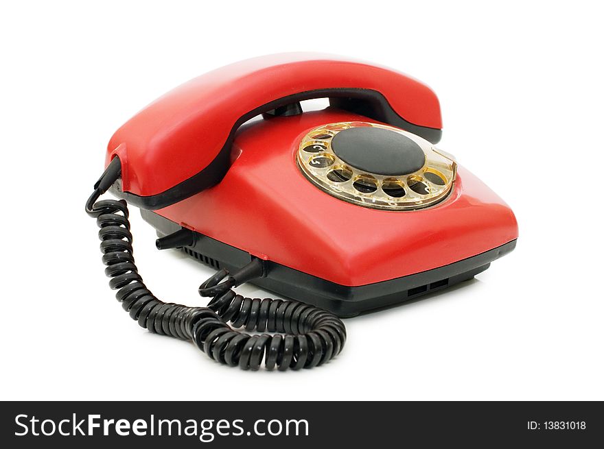 Red old telephone over white