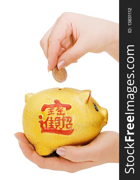 Piggy bank and hand with coin isolated over white