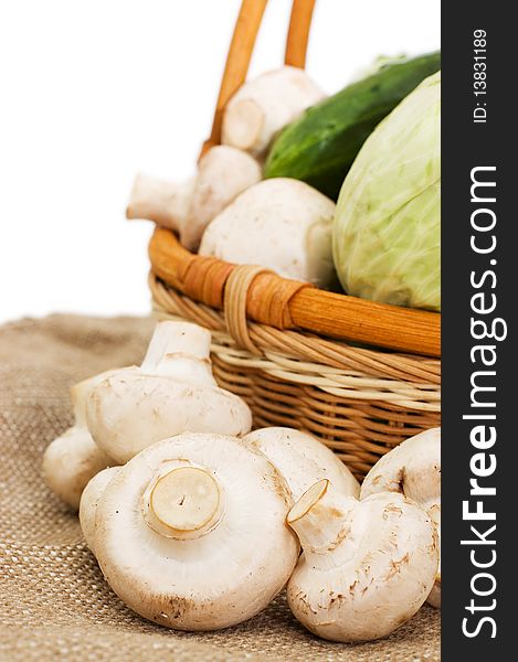 Wattled basket with vegetables isolated on white