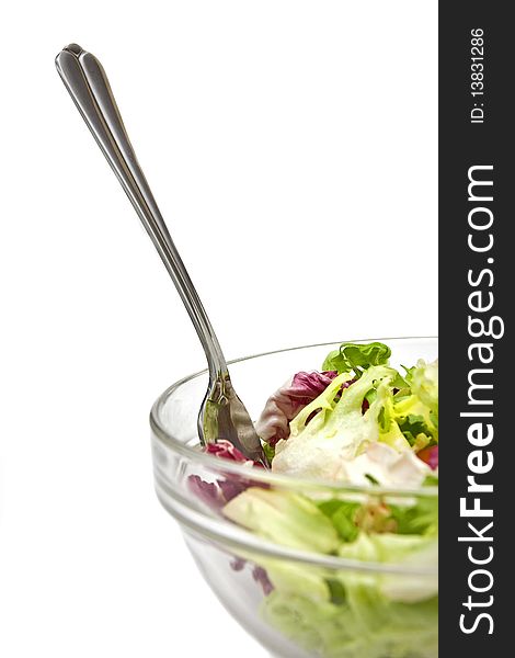 An image of a fresh salad with a fork in it's recipient