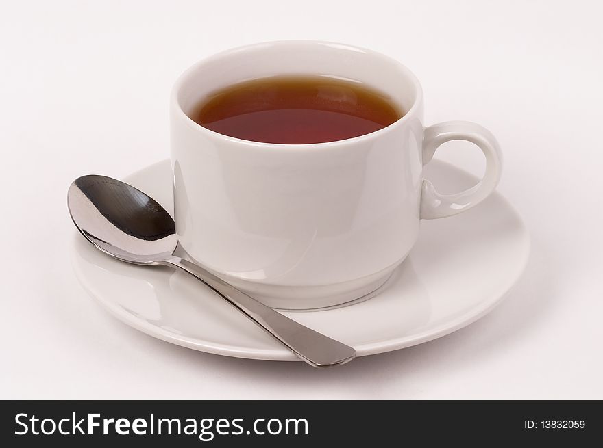Little white tea cup isolated over grey gradient background
