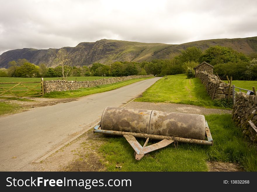 Farm roller set in the background of the western lake district area Cumbria. Farm roller set in the background of the western lake district area Cumbria