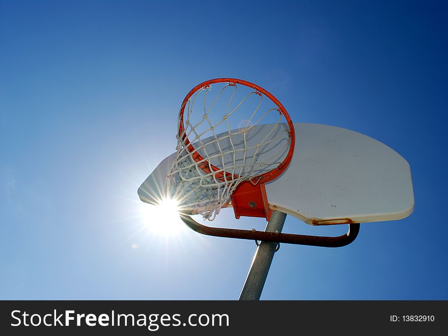 Basketball hoop with blue sky in the background