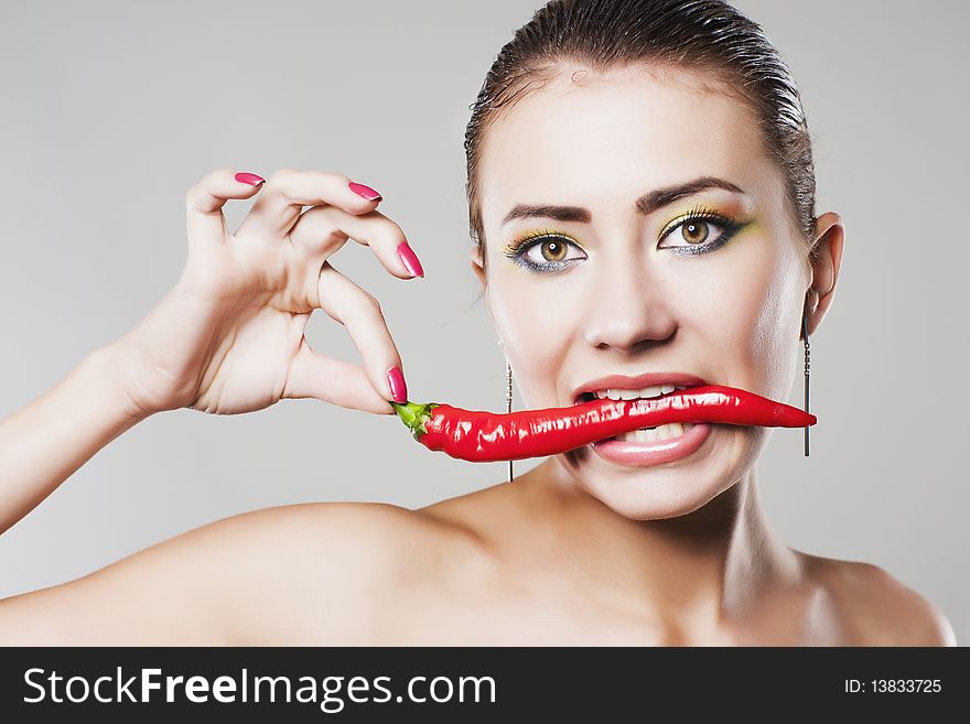 Girl eat hot chili pepper