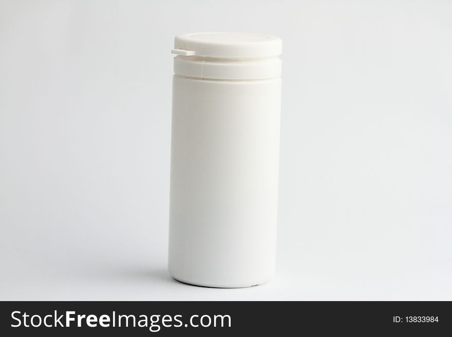 White pill bottle without label on white background.