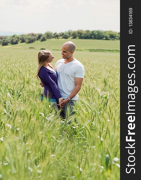 Young happy attractive couple in the grass