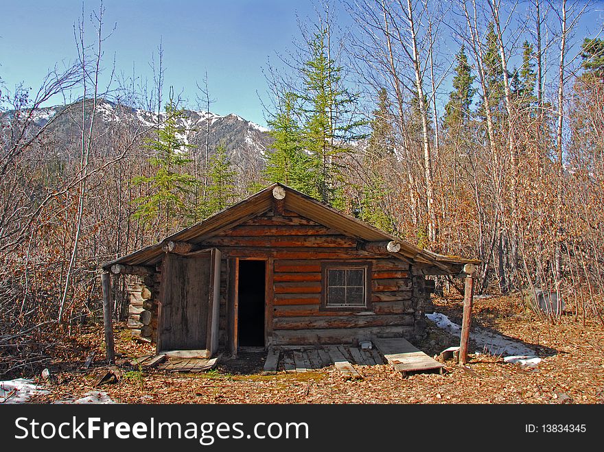 Log cabin in Alaska in Autumn with mountains