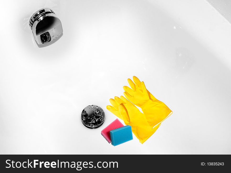 Housework process represented by two sponges pink and blue one that lay down a just cleaned bath near the drain hole. Housework process represented by two sponges pink and blue one that lay down a just cleaned bath near the drain hole