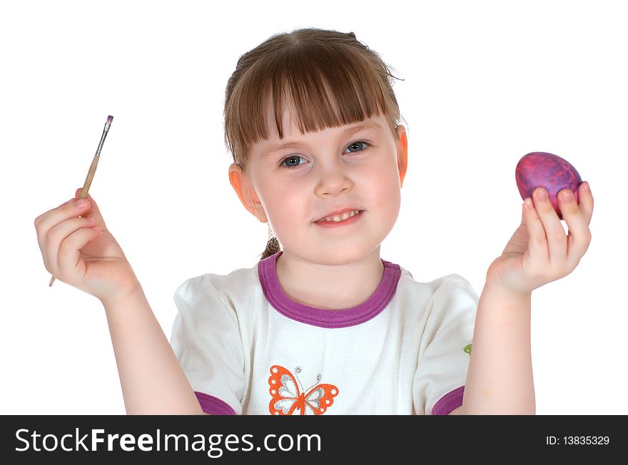 Girl dyes egg by tassel and smiles on white background. Girl dyes egg by tassel and smiles on white background