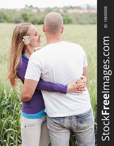 Young romantic couple standing together in the park