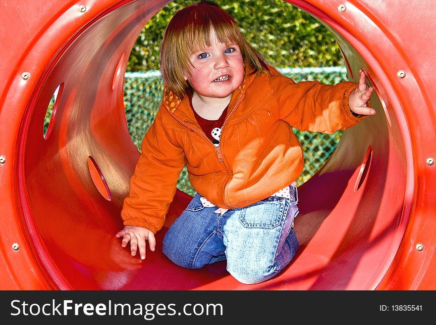 Child in a red tube playing. Child in a red tube playing