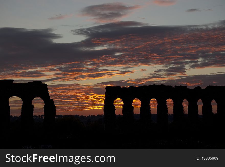 Sunset on ancient roman aqueduct