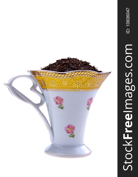 Selected dry black tea leaves in beautifull cup