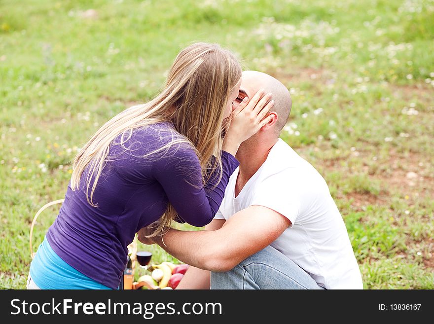 An attractive couple sharing a passionate kiss, outdoors